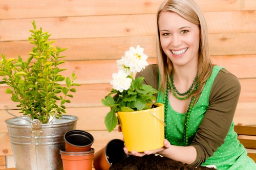 A gardener tending to plants in a Chigwell garden during spring.